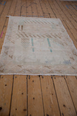 Corner of distressed Sparta rug with worn pile, visible foundation, and fringe.