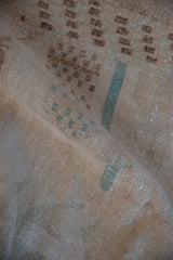 Distressed vintage Sparta rug showing soft worn texture, faint brown and dusty teal motifs.