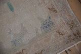 Distressed vintage Sparta rug texture: worn knot heads, visible foundation, ivory, blue, brown.