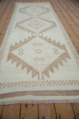 Kurd rug runner's cream and coffee brown geometric pattern with serrated lightning and checkered border.
