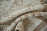 Cream and brown distressed pile with textured folds on a vintage hand-knotted Kurd rug.