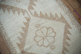 Vintage Kurd rug detail: cream floral and serrated lightning motifs on short pile.