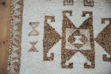 The original side cord selvage and short, textured wool pile on a distressed Kurd rug runner.