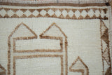 Textured ivory pile and primitive coffee brown geometric border on vintage distressed Kurd runner.