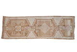 Distressed Kurdish runner with three large geometric medallions in sandy beige and coffee brown hues.