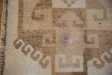 Distressed hook motif, fuchsia detail, and intact side selvage on a vintage Kurd runner.