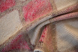 Folded, distressed pile texture of the vintage Kurd runner in fuchsia, pale aubergine, and ivory.