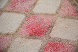 Distressed pile texture of vintage Kurd rug runner with fuchsia and ivory diamond panels.