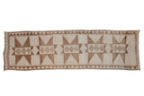 Distressed Kurd rug runner with geometric starburst medallions in coffee brown and ivory.