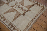 Angled view of the distressed Kurd runner's low-pile texture and original side cord.