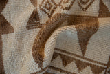 The textured, low pile of a hand-knotted vintage Kurd rug in bronze and ivory.