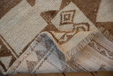 Detail of the hand-knotted back, original selvage, and fringe of a vintage Kurd rug.