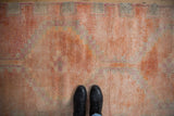 Distressed Kurd runner: muted coral, fuchsia, ivory tones, geometric pattern, and even wear.