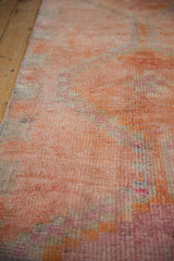 Distressed vintage Kurd runner pile showing faded coral, orange, and antique ivory.