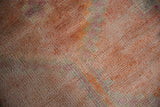 Distressed pile texture of a vintage Kurd rug with faded coral and fuchsia checkered pattern.