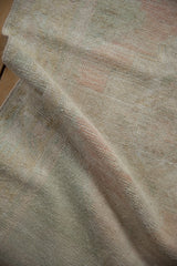 Distressed vintage Oushak rug pile, showing even wear and subtle faded ivory, blush tones.