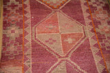 Primitive geometric diamond motif with distressed pile in fuchsia, rose, and ivory on Kurd runner.