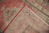 Distressed vintage Kula rug pile showing dusty red wear and hand-knotted foundation.