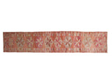 Vintage distressed Kurd rug runner with geometric starburst medallions in hues of pink grapefruit red and ivory.