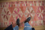 A personal perspective of the distressed Kurd runner's textured pile and geometric starburst medallions.