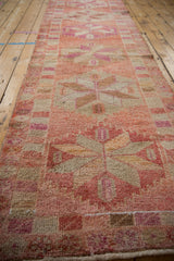 Low angle perspective down the Kurd runner highlighting its textural short pile and abrashed pink and fuchsia tones.
