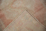 Distressed Oushak rug back with woven foundation and worn dusty rose pile.
