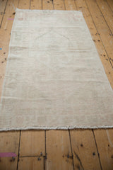 Distressed vintage Oushak rug surface showing mostly even wear and subtle neutral-toned hues.