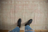 Distressed Oushak runner with subtle curvilinear pattern, pale pink, ivory, and dusty green gold.