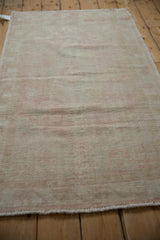 Vintage distressed Oushak runner close-up, worn pile, exposed foundation, pale pink, ivory.