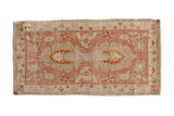 Vintage distressed Oushak runner with a pale raspberry palmette design on antique ivory.