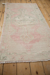 Angled view of the vintage Oushak runner showing its characterful distressed texture and low pile.
