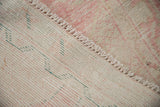Close-up on the back of a vintage Oushak runner, detailing the hand-knotted weave and selvedge.