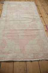 Distressed vintage Oushak rug runner's pile texture, with pink and beige tones and visible knot heads.