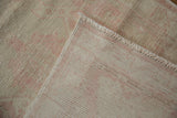 Hand-knotted foundation and worn pink-beige pile of vintage Oushak rug runner.