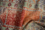 Distressed vintage Oushak rug texture with visible knot heads and foundation in terracotta, green.