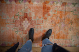 Textured pile of distressed Kurd runner, tangerine, green, and wine red checkered patterns.