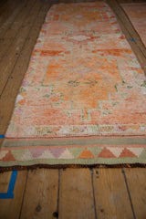 Distressed vintage Kurd runner with abrashed tangerine field and geometric multi-color border.