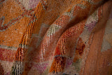 Textured distressed pile of vintage Kurd runner, with nuanced tangerine orange and green hues.
