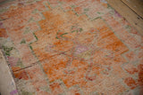 Distressed Kurd runner pile, featuring abrashed tangerine, green, and pink geometric designs.
