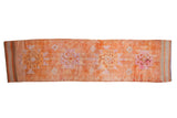 Distressed vintage Kurd runner rug, tangerine orange with fuchsia and purple geometric medallions.