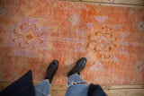 Distressed Kurd runner, geometric medallions and nuanced vines in tangerine, fuchsia, saffron tones.