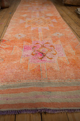 Distressed tangerine orange Kurd rug pile, with fuchsia and purple medallion patterns.