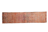Vintage distressed Kurd runner with muted pink, tangerine orange, and charcoal medallions.
