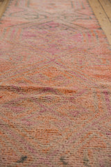 Distressed Kurd rug pile showing blend of pink, orange, purple, and charcoal tones.