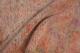 Distressed vintage Kurd rug pile showcasing variegated pink, orange, and charcoal shades.