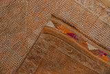 Distressed vintage Kurd runner texture, showing tangerine, ivory pile and bright fuchsia side.