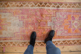 Distressed vintage Kurd runner, geometric pink, tangerine, cream patterns, chevron border.
