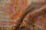 Vintage distressed Kurd rug pile in warm orange, magenta, and muted beige tones.
