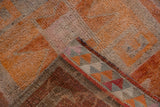Distressed Kurd runner pile, tangerine and silver geometric blocks, revealing hand-knotted reverse.