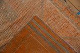 Textured pile of Vintage Distressed Kurd rug showing knot wear, pale orange, and striped foundation.